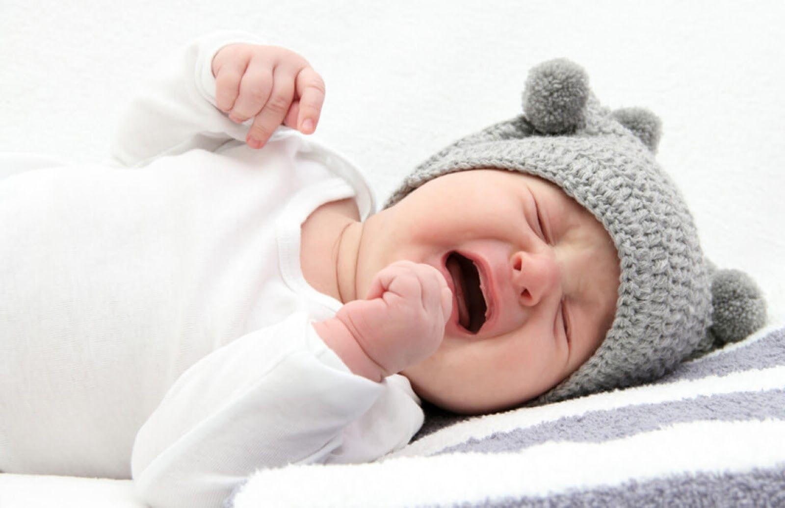 Một em bé gái sơ sinh với biểu cảm đáng yêu khi khóc